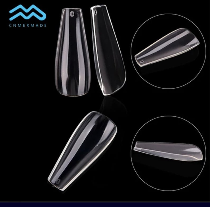 May include: Clear plastic nail tips in a coffin shape. The tips are shown from different angles.