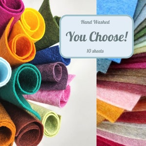 May include: A collection of colorful felt sheets in various shades, including pink, orange, green, and blue. Rolled felt sheets are displayed alongside a stack of flat felt sheets. The text "Hand Washed, You Choose! 10 sheets" is visible.
