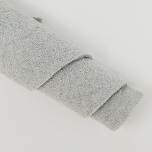May include: A roll of light gray felt fabric.