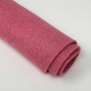 May include: A roll of pink felt fabric. The felt is soft and fuzzy, and it is perfect for crafting projects.