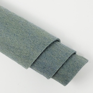 May include: A roll of light blue felt fabric. The fabric is soft and textured.