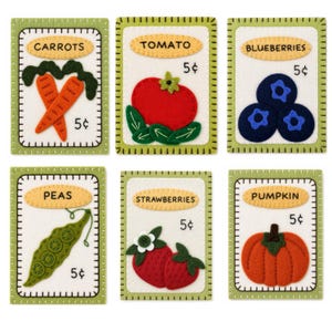May include: Set of six felt vegetable cards. Each card features a different vegetable: carrots, tomato, blueberries, peas, strawberries, and pumpkin. Each card has a green border, a white background, and the vegetable's name.