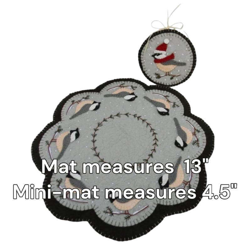May include: A set of two felt needlepoint floor mats featuring a wintery scene with birds. The larger mat measures 13 inches in diameter and the smaller mat measures 4.5 inches in diameter.