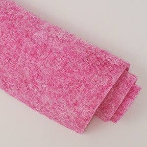 May include: A roll of pink felt fabric. The felt is soft and fuzzy, and it is perfect for crafting projects.