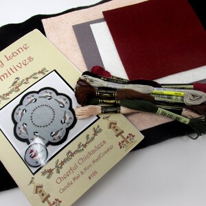 May include: A craft kit for making a cheerful chickadee candle mat or mini coaster. The kit includes a pattern, felt pieces in various colors, and embroidery floss. The pattern shows a circle of birds with a small bird in the center.