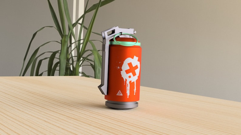 May include: Orange and gray grenade with a white plus sign and a green ring around the top. The grenade is on a wooden surface.