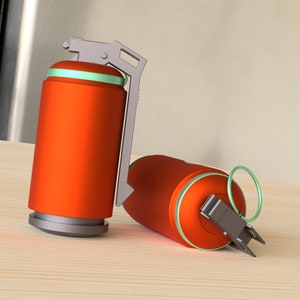 May include: Two orange and gray smoke grenades with a green ring around the top. The grenades are on a light brown wooden surface.