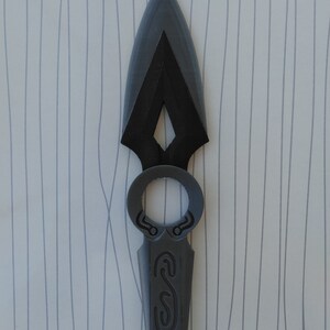 May include: A gray 3D printed spearhead with a decorative ring and a detailed design on the handle.