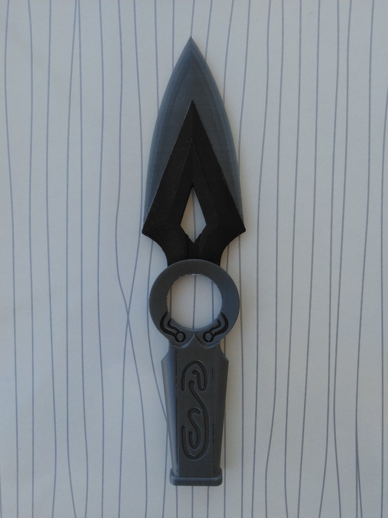 May include: A gray 3D printed spearhead with a decorative ring and a detailed design on the handle.