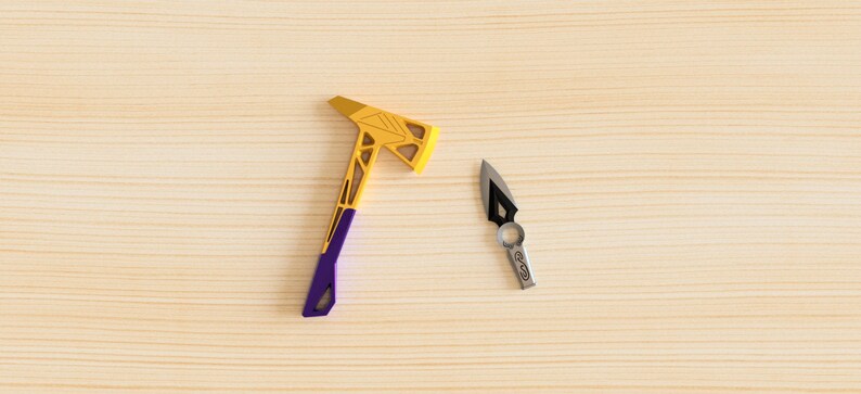 May include: A small purple and gold axe and a small silver knife with a black handle on a light wood surface.
