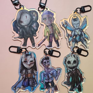 May include: A set of six acrylic keychains featuring illustrated horror-themed characters. Each charm displays a unique figure with detailed clothing, weapons, and expressive faces, attached to a black metal lobster clasp for easy hanging.