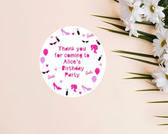 May include: Pink and white round sticker with the text "Thank you for coming to Alice's Birthday Party". The sticker is decorated with pink lipstick, shoes, sunglasses, and balloons. The text "Barbie" appears multiple times on the sticker.