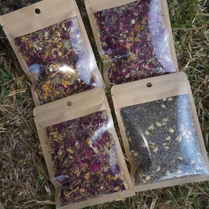 May include: Four small brown paper bags with clear plastic windows, each containing a different blend of dried herbs and flowers. The bags are labelled "Sleep".
