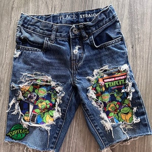 Distressed character fabric shorts or jeans