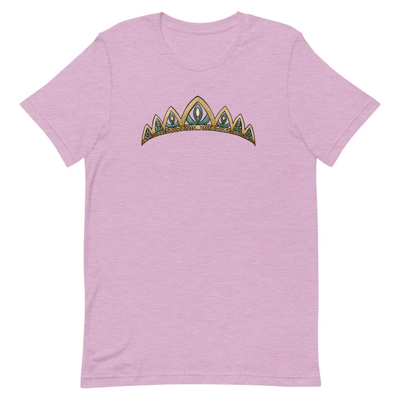 May include: A light pink t-shirt with a gold and green crown graphic.
