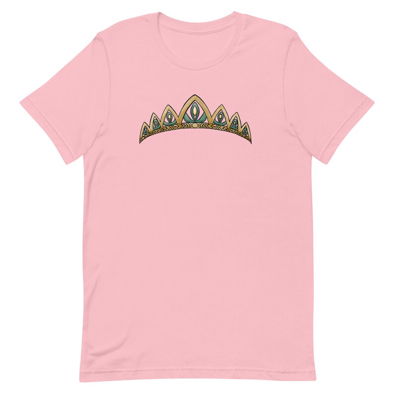 May include: A pink t-shirt with a gold and green crown design.