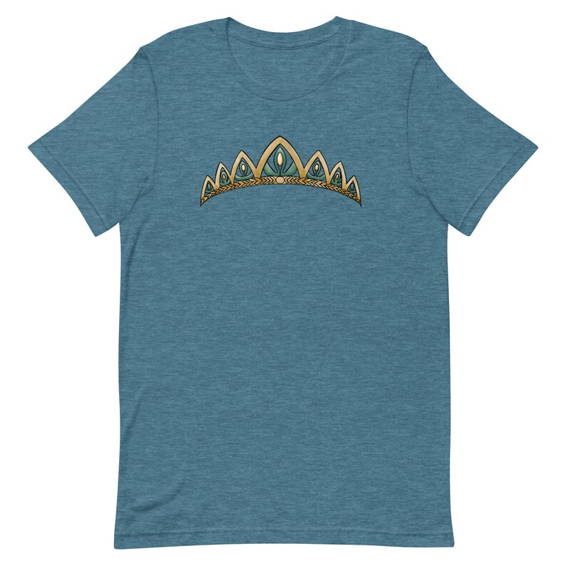 May include: A teal blue t-shirt with a gold and green crown design.