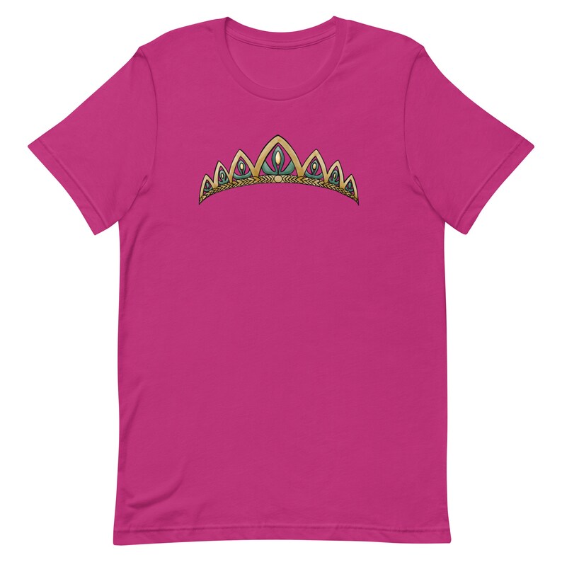 May include: A pink t-shirt with a gold and green crown design.
