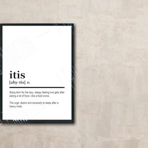 May include: A framed print with the word "itis" in bold, black letters. Below, the pronunciation and definition are provided. The definition describes the feeling of sleepiness after eating a large meal. The frame is black.