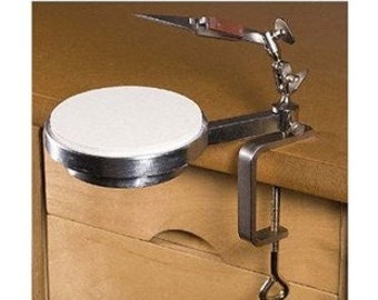 May include: A silver clamp-on desk mount with a white ceramic polishing wheel. The mount has a swivel arm with a small tool holder.