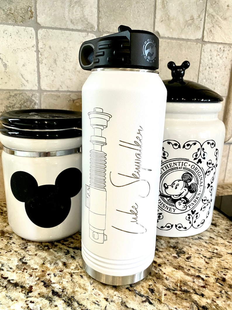 32oz Star Wars Lightsaber Water Bottles. These are laser engraved  with your favorite Jedi Lightsaber and signature like Darth Vader, Luke Skywalker, Obi-Wan Kenobi, Kylo Ren, Ahsoka Tano, and more! These can also be personalized.