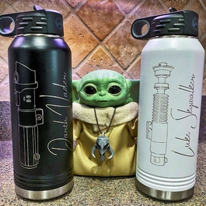 32oz Star Wars Lightsaber Water Bottles. These are laser engraved  with your favorite Jedi Lightsaber and signature like Darth Vader, Luke Skywalker, Obi-Wan Kenobi, Kylo Ren, Ahsoka Tano, and more! These can also be personalized.