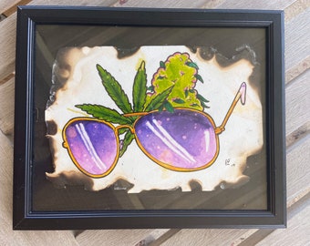 Watercolor sunglasses with cannibis on burned paper