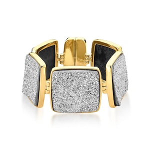 May include: A gold bracelet with a square design. Each square is covered in small, white stones.