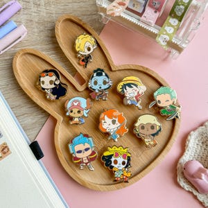 May include: A set of three ceramic mugs with a speckled, matte finish. The mugs are in shades of cream, light gray, and dark gray. Each mug has a simple, minimalist design, perfect for coffee or tea.