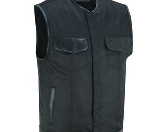 May include: Black leather motorcycle vest with a snap closure, two flap pockets, and a black leather trim around the neck and bottom.