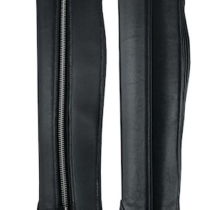 May include: A pair of black leather riding boot gaiters with a zipper down the front. The gaiters have a pointed toe and a smooth finish.