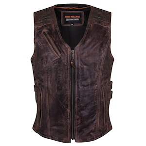 May include: A distressed brown leather vest with a zip-up front, featuring a textured shoulder panel and multiple pockets. The vest has a V-neck design and a label that reads "HIGH MILEAGE LEATHER GEAR".