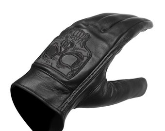 May include: Black leather gloves with a skull design embroidered on the back of the hand.