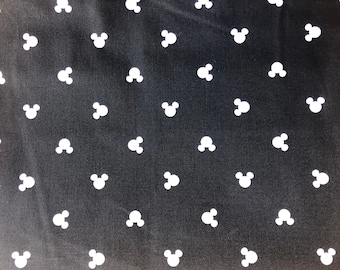 May include: Black fabric with a white repeating pattern of Mickey Mouse heads.