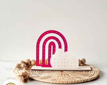 May include: A pink and white rainbow and cloud earring holder with a polka dot design. SVG Laser File digital download.