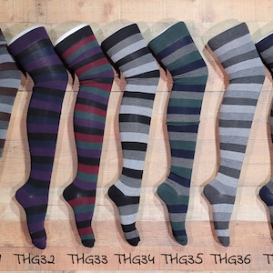 May include: Seven pairs of striped thigh-high socks in various color combinations, including brown, purple, green, gray, and black. The socks are displayed on a wooden surface with the product codes THG31 through THG37.