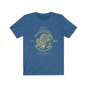 May include: A blue t-shirt with a yellow graphic of a jaguar in a circle with the text "House Jaguar Est. 1880 Baton Rouge Louisiana".