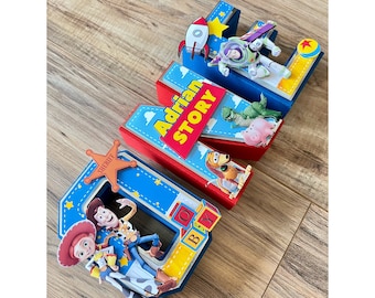 May include: Toy Story themed letter blocks spelling out the name "Adrian" with the words "Story" and "Boy" on the blocks. The blocks are decorated with characters from the movie, including Woody, Buzz Lightyear, Rex, and Hamm.