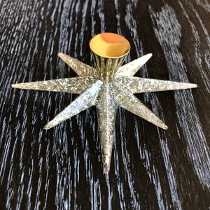 May include: A gold star-shaped cabinet knob with a textured surface.