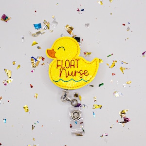 May include: Yellow rubber ducky with the text "FLOAT NURSE" embroidered on it. The ducky is attached to a clear retractable badge holder.