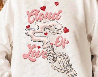 May include: White sweatshirt with a pink graphic of a skeleton hand holding a lit joint with smoke that says "Cloud of Love" with pink hearts around it.