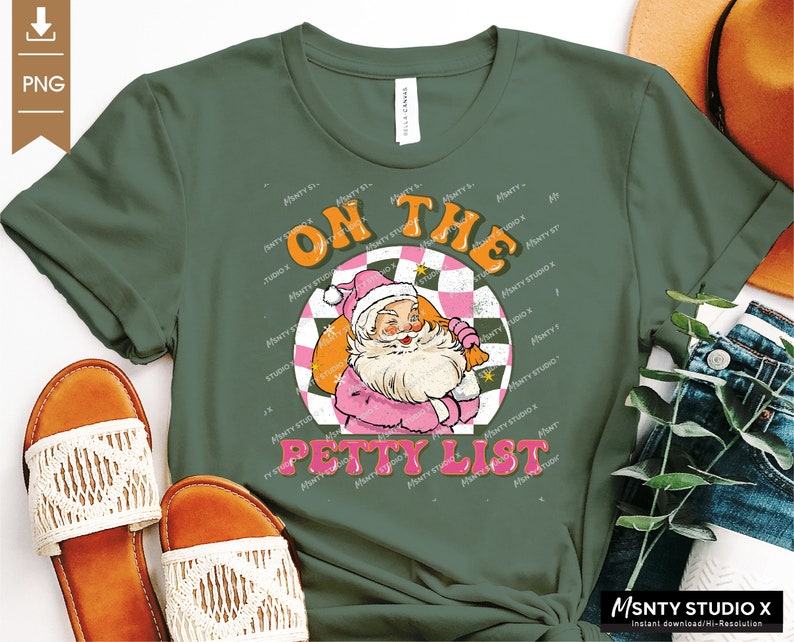 May include: A green t-shirt with a retro-style graphic of Santa Claus in a pink suit. The graphic says "On the Petty List" in a colorful, vintage font.