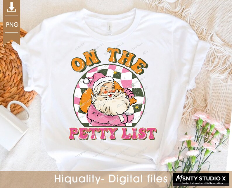 May include: A white t-shirt with a pink and green graphic of Santa Claus with the text "On the Petty List".