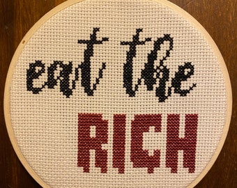 Framed cross stitch "eat the rich”