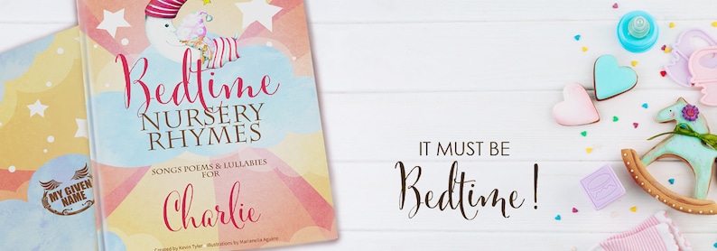 May include: A personalised book titled "Bedtime Nursery Rhymes" with a watercolour background and the name "Charlie" printed on the cover. The book is open to reveal colourful illustrations and the text "Songs, Poems & Lullabies for Charlie".