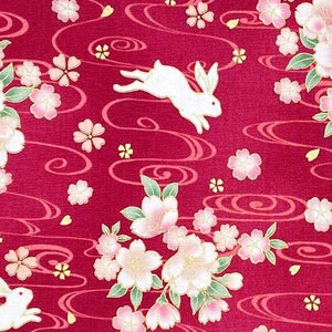 Japanese fabric -- Bunnies hopping through cherry blossoms with metallic gold highlights on raspberry red -- 100% cotton quilting fabric