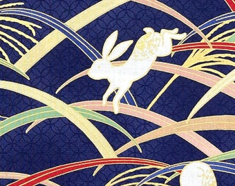 Japanese fabric -- Bunnies hopping through multicolor grass with metallic gold highlights on navy blue -- 100% cotton quilting fabric