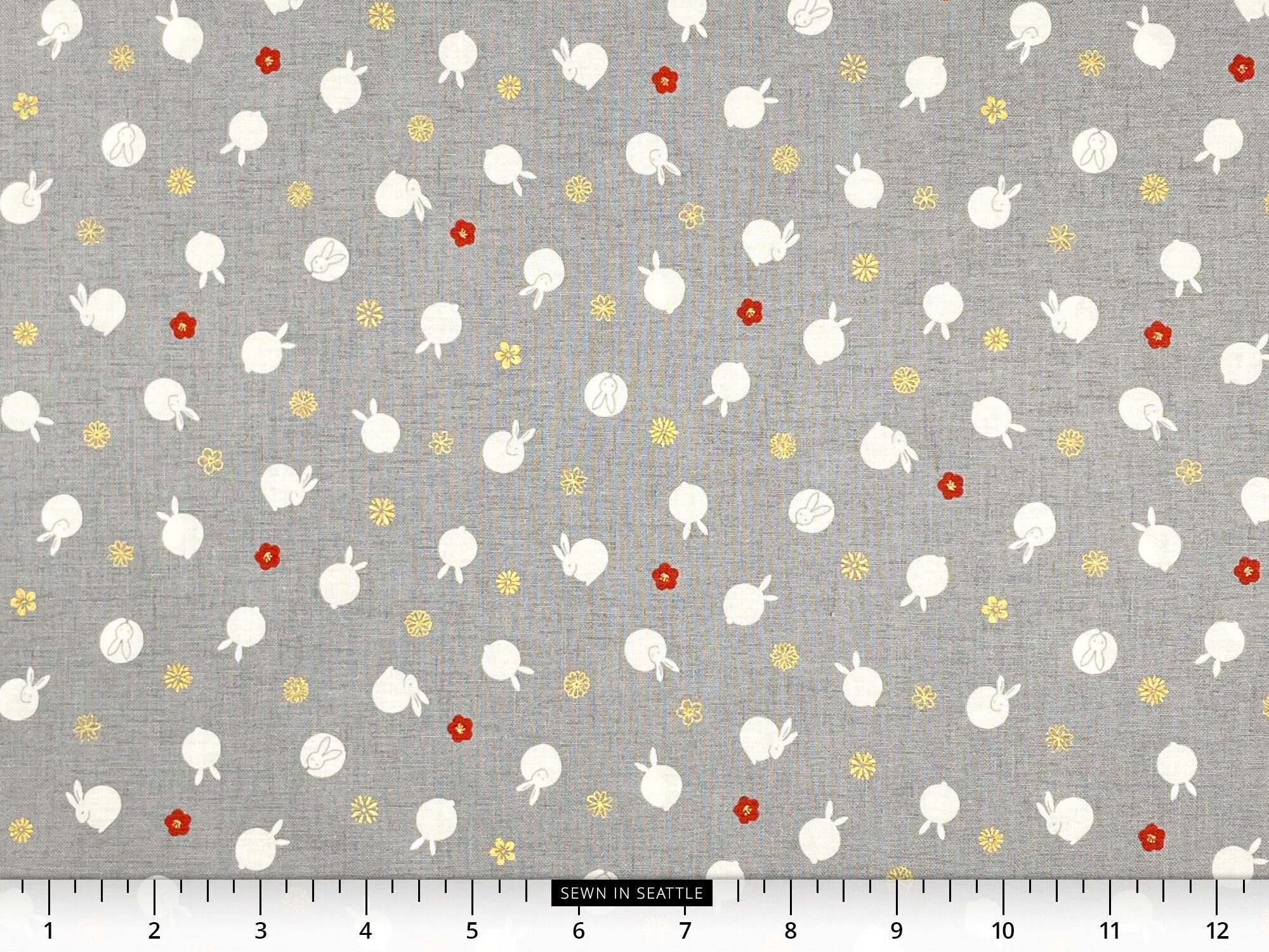 Japanese fabric -- Small bunnies and mini orangey-red and metallic gold flowers repeated on gray -- 100% cotton quilting fabric