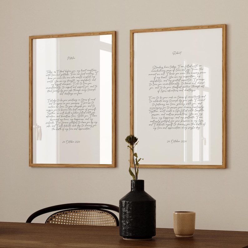 Two framed vow prints featuring in modern calligraphy style, displayed on a shelf with decorative accents.