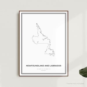 May include: A black and white line art print of the outline of Newfoundland and Labrador, Canada. The print includes the coordinates 53.1355° N / 57.6604° W and the text "Newfoundland and Labrador, Canada".
